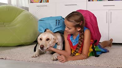 Girl playing with dog dressed for school
