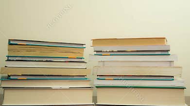 Stacked books on dark wooden background. Reading concept. Time lapse. Accelerated frame-by-frame shooting
