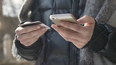 Female hands hold a large black smartphone and credit card, online banking, shopping, online store 60 fps