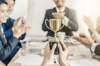 Winning business team gold trophy , business team happy consent