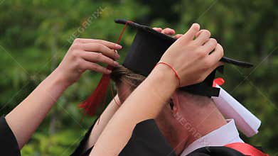 Happy male graduate wearing academic cap and smiling, graduation ceremony