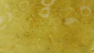Abstract close-up on the surface of boiling water and oil