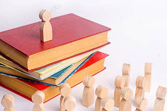 A man stands on a pile of books before the audience and makes a speech. A smart leader manages employees and leads them along.