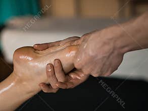 Professional Masseur Doing Deep Tissue Oiled Massage to a Girl at Ayurveda Massage Session