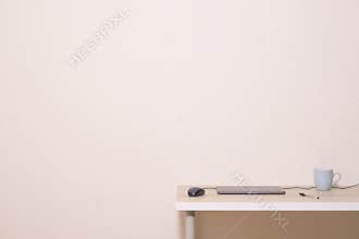 Blank white advertisement wall above office home desk cup laptop mouse pen neutral empty background