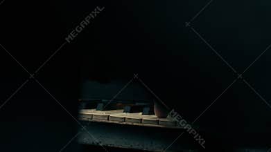 The man plays grand piano - all on fire