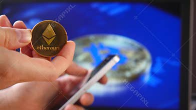 Trade in the house crypto currency. Close-up of a smartphone and coins of Litecoin LTC, BitCoin BTS, Ethereum ETX, and