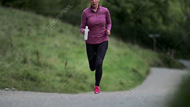 Senior Woman Running in the Lake District