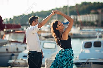 Romantic couple dancing on the street. Having a romantic date. Celebrating anniversary. Valentines day. Birthday date