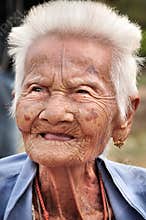 SUKHOTHAI, THAILAND - DECEMBER 15: Street portrait of Thai late 85’s female at Wat Srichum temple in SUKHOTHAI THAILAND on DECEM
