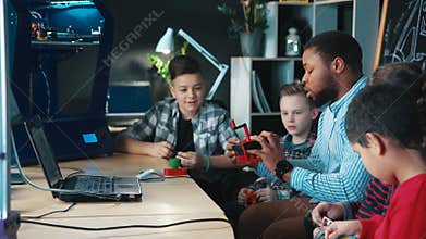 Teacher with kids exploring 3d printing