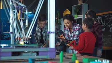 Teacher and kids exploring 3d modeling