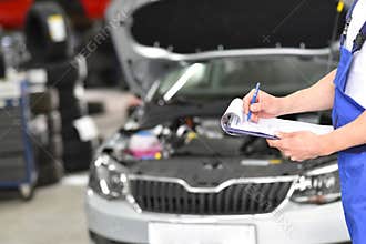 Service and inspection of a car in a workshop - mechanic inspect