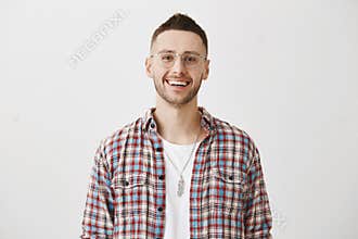 Always nice to talk with smart person. Indoor shot of attractive interesting caucasian guy smiling broadly while