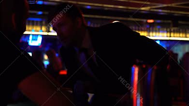Businessman ordering drinks at bartender after successful meeting, relaxation