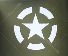 White US army star in an invasion circle stenciled on an olive green painted military vehicle