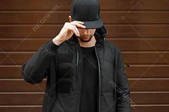 Young man in a black fashionable baseball cap