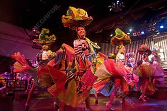 A team of graceful dancers dancing with joy in one of the performance in Parisien Cabaret, Havana, Cuba