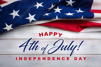 American flag on a white worn wooden background with July 4th Greeting