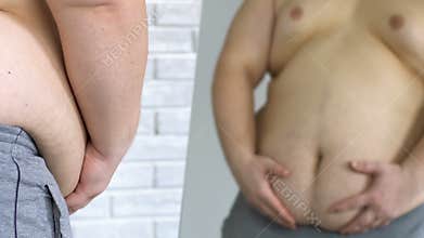 Unhappy obese male looking at his fat belly in mirror, weight loss, insecurities