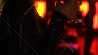 Young lady dancing with cocktail glass, enjoying night club music, weekend relax