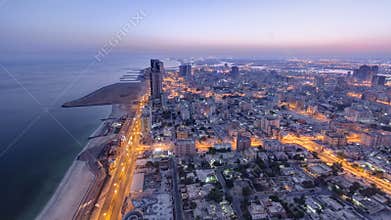 Cityscape of Ajman from rooftop night to day timelapse. Ajman is the capital of the emirate of Ajman in the United Arab Emirates.