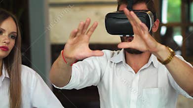 Team of developers working with virtual reality glasses during a business meeting. Young business colleagues