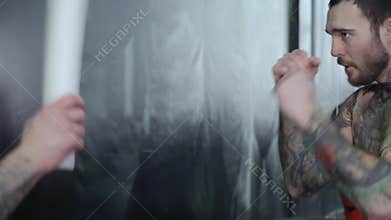 Two boxers with tattoos box in the gym