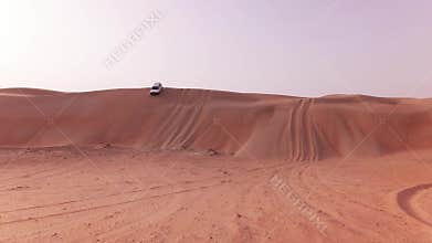 Off-road cars with tourists descend from a high dune in Rub al Khali desert stock footage video