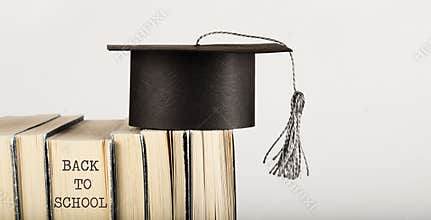 Academic hat on books. Free space for a text.