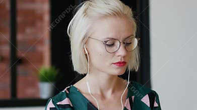 Elegant woman listening to music at home