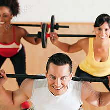 Fitness group with barbell in gym