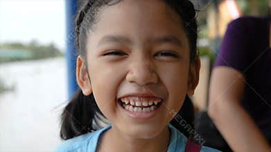 Cute Asian little girl is smile and laughing with happiness