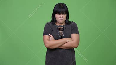 Angry overweight Asian woman with arms crossed