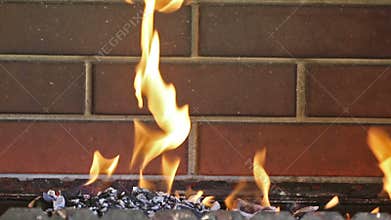 Orange fire on brick wall background
