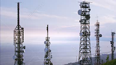 Aerial view of telecommunications towers antennas and cityscape in the background