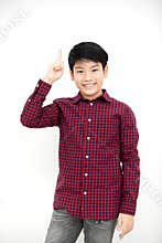 Asian boy smiling and pointing finger up .