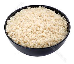 Boiled rice in a black bowl close-up isolated