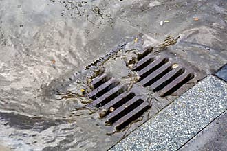 Rain flowing into a storm water sewer system