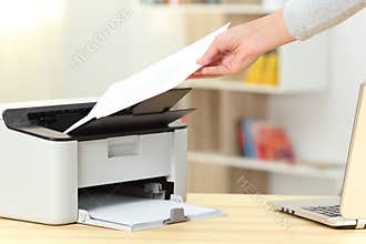 Woman hand catching a document from a printer