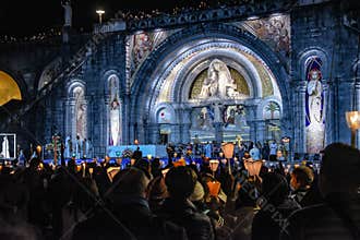 Pilgrims attend the Marian Torchlight Procession service at the Rosary Basilica in Lourdes