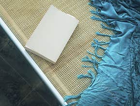 Teal sarong with a summer book. Copy space