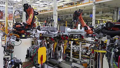 work of robots on a car assembly line, a modern huge factory