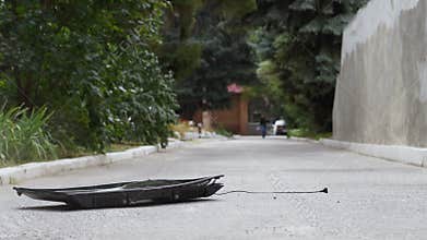 Modern flat screen TV falls on the asphalt from a height and crashes in slow motion