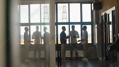 businessmen with name tags talking at office
