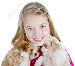 Smiling girl hugging puppies