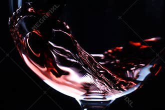 Closeup of red wine pouring