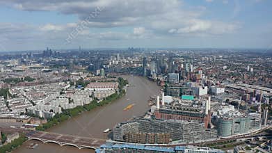 Old coal burning Battersea Power Station at Thames river bank and modern apartment houses around. Aerial panoramic view