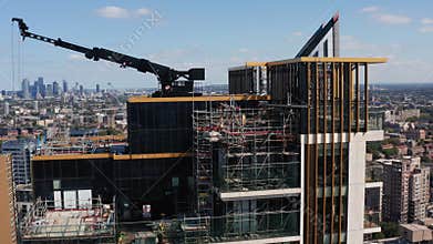 Orbit around construction site on top of tall building. Scaffolding and crane of skyscraper roof. London, UK