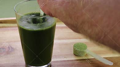 A Hand Stirring Organic Celery Powder with Aloe Vera Juice